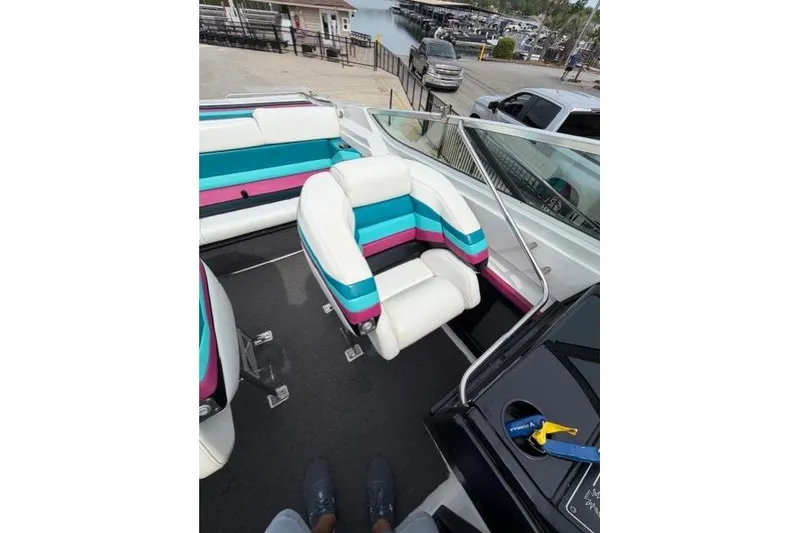 Slide: The Image of 1989 Formula 292 SR-1 boat interior with colorful seating at a marina. - 7
