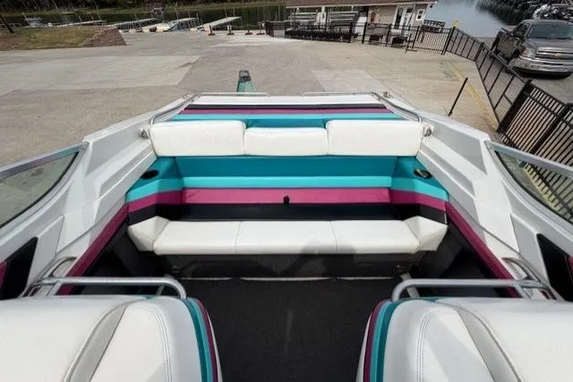 Slide: The Image of 1989 Formula 292 SR-1 boat interior with colorful seating at a marina. - 8