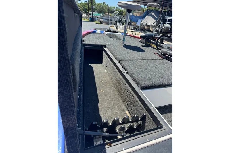 Slide: The Image of Open storage compartment on a 2005 Skeeter ZX225 boat, showing interior details. - 10