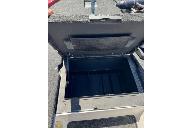 Slide: The Image of Open storage compartment in a 2005 Skeeter ZX225 boat. - 11