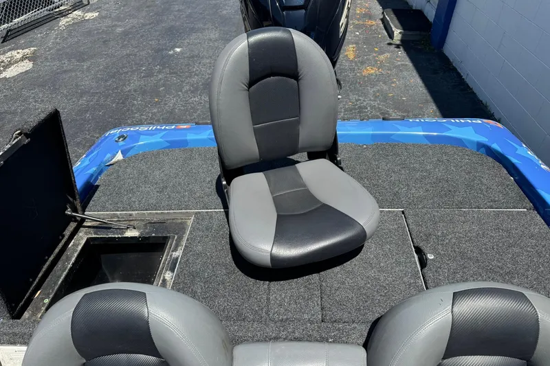 Slide: The Image of 2005 Skeeter ZX225 boat interior with gray seating and storage compartment. - 13