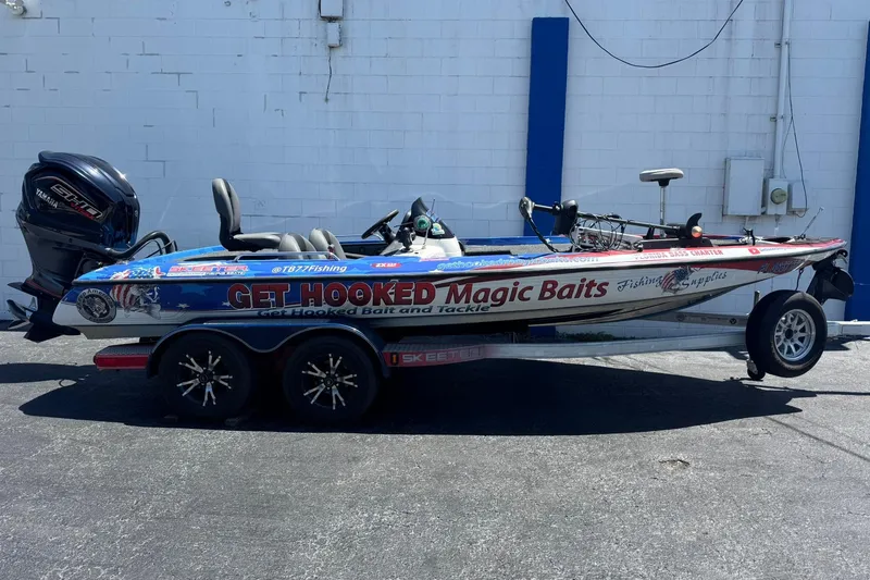 The Image of 2005 Skeeter ZX225 fishing boat with custom "Get Hooked Magic Baits" graphics on trailer. - 2