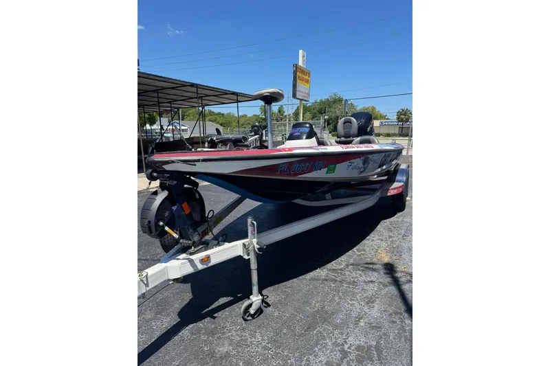 Slide: The Image of 2005 Skeeter ZX225 bass boat on trailer in sunny outdoor setting. - 4