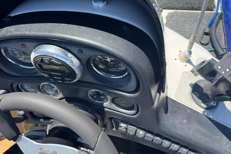 Slide: The Image of Dashboard of a 2005 Skeeter ZX225 boat with steering wheel and controls. - 6