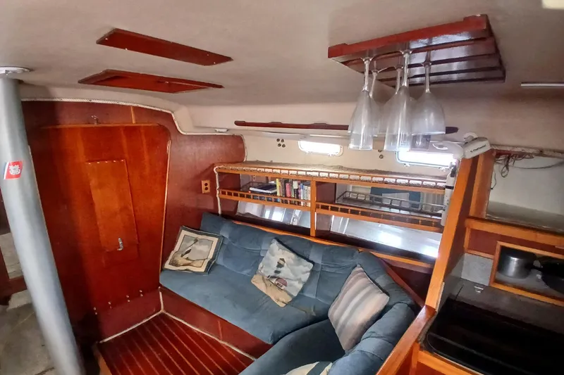 Slide: The Image of Interior of 1982 Morgan 416 sailboat with cozy seating and wooden accents. - 15