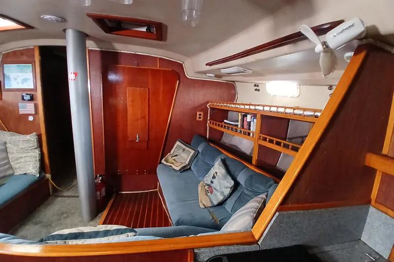 Slide: The Image of Interior of a 1982 Morgan 416 sailboat with cozy seating and wooden accents. - 18