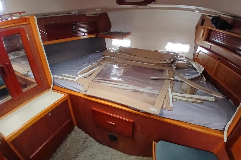 Slide: The Image of 1982 Morgan 416 yacht interior cabin with wooden furnishings and bed. - 20