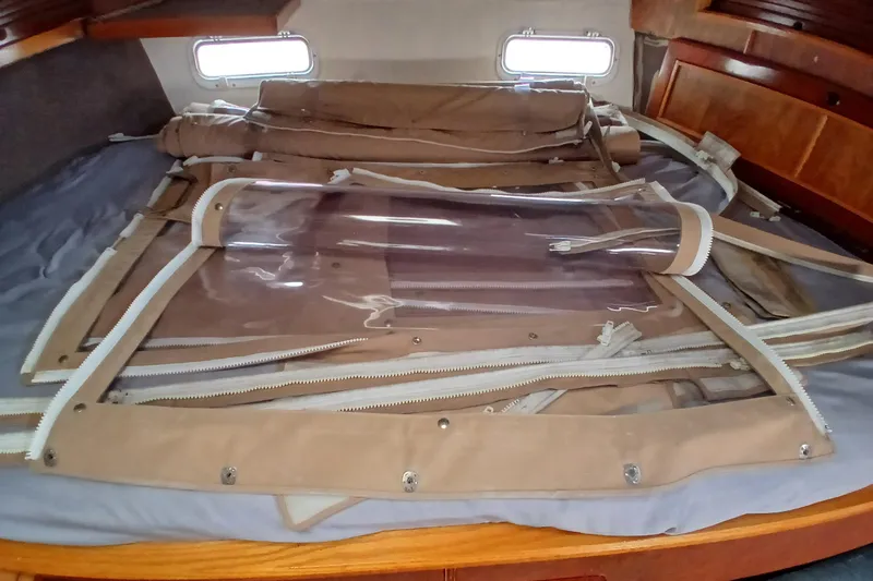Slide: The Image of Interior of a 1982 Morgan 416 sailboat with folded canvas and clear panels. - 22