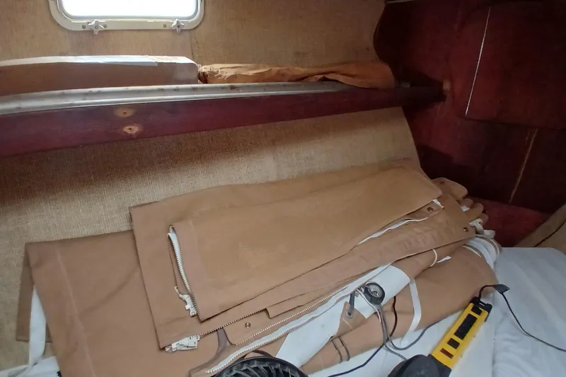 Slide: The Image of Interior of a 1982 Morgan 416 sailboat with folded sails and equipment. - 27