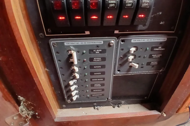 Slide: The Image of Electrical panel of a 1982 Morgan 416 boat, featuring switches and circuit breakers. - 29