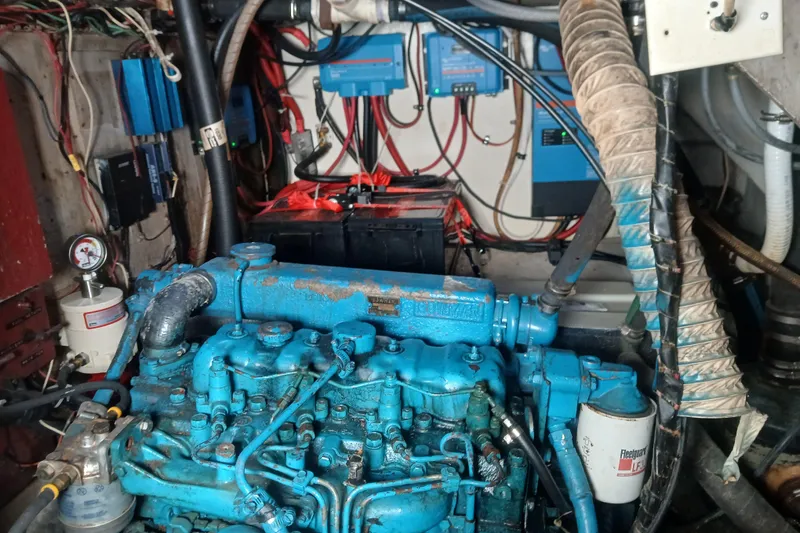 Slide: The Image of 1982 Morgan 416 engine room with blue engine and wiring. - 30