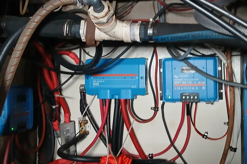 Slide: The Image of Electrical system with blue power inverters and wiring in a 1982 Morgan 416 boat. - 32