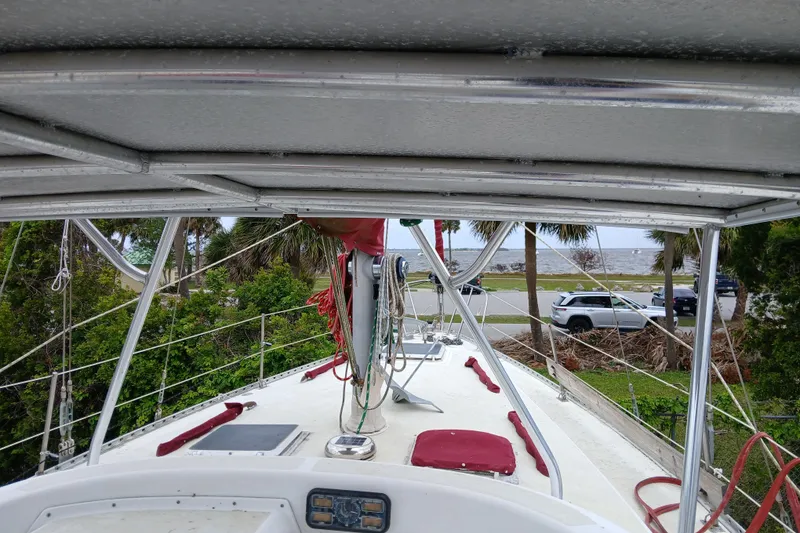 Slide: The Image of 1982 Morgan 416 sailboat deck view with ocean and palm trees in background. - 5