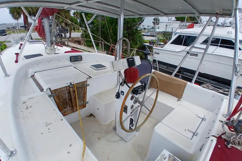 Slide: The Image of 1982 Morgan 416 sailboat cockpit with steering wheel and navigation equipment. - 6