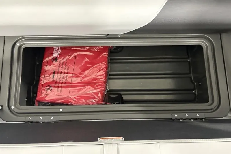 Slide: The Image of Storage compartment with red life jacket in 2026 Sun Tracker SportFish 20 DLX boat. - 10