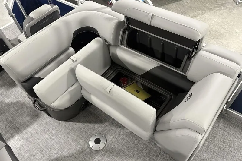 Slide: The Image of 2026 Sun Tracker SportFish 20 DLX boat interior with open storage compartments and cushioned seating. - 12
