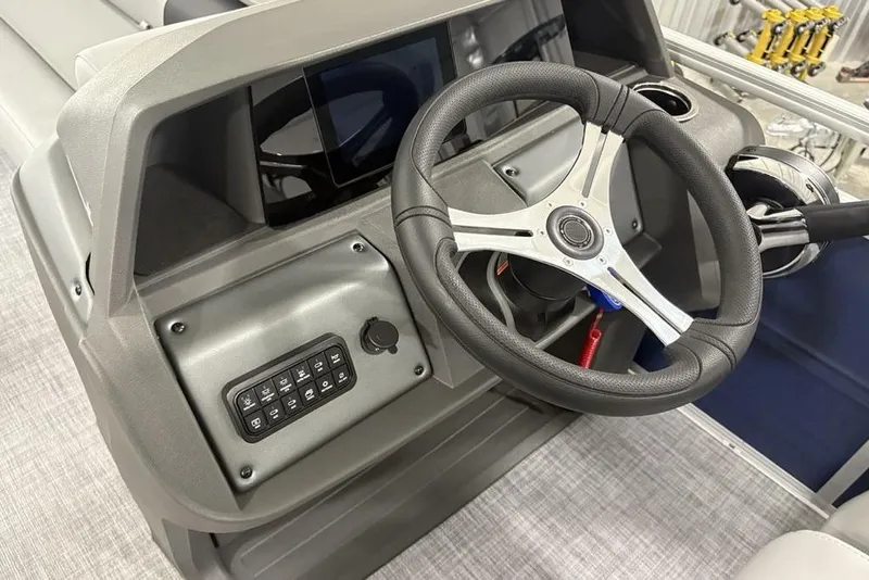 Slide: The Image of 2026 Sun Tracker SportFish 20 DLX steering console with modern controls and sleek design. - 28