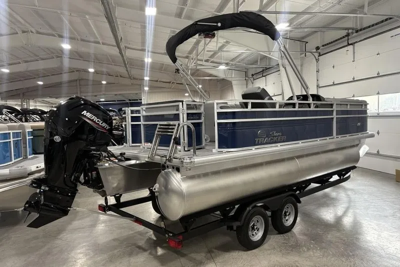 Slide: The Image of 2026 Sun Tracker SportFish 20 DLX pontoon boat with Mercury engine in a showroom. - 3