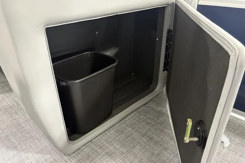 Slide: The Image of Storage compartment with trash bin in 2026 Sun Tracker SportFish 20 DLX boat. - 7