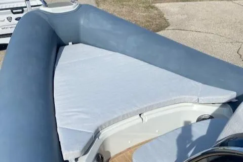 Slide: The Image of 2022 SACS Strider 900 boat with cushioned seating area. - 10