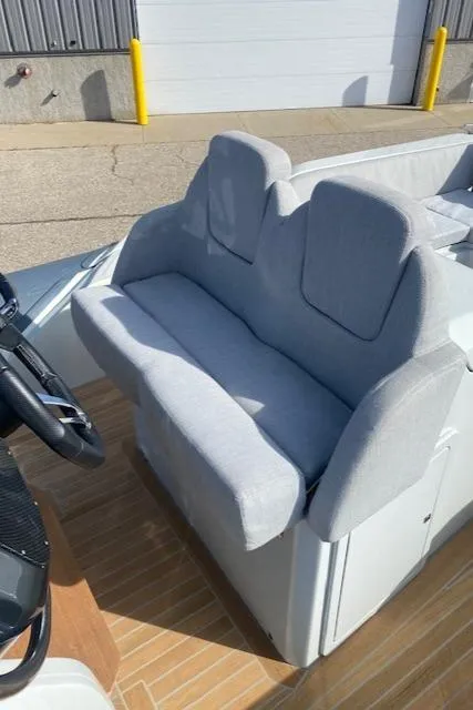 Slide: The Image of 2022 SACS Strider 900 boat interior with cushioned seating and steering wheel. - 11