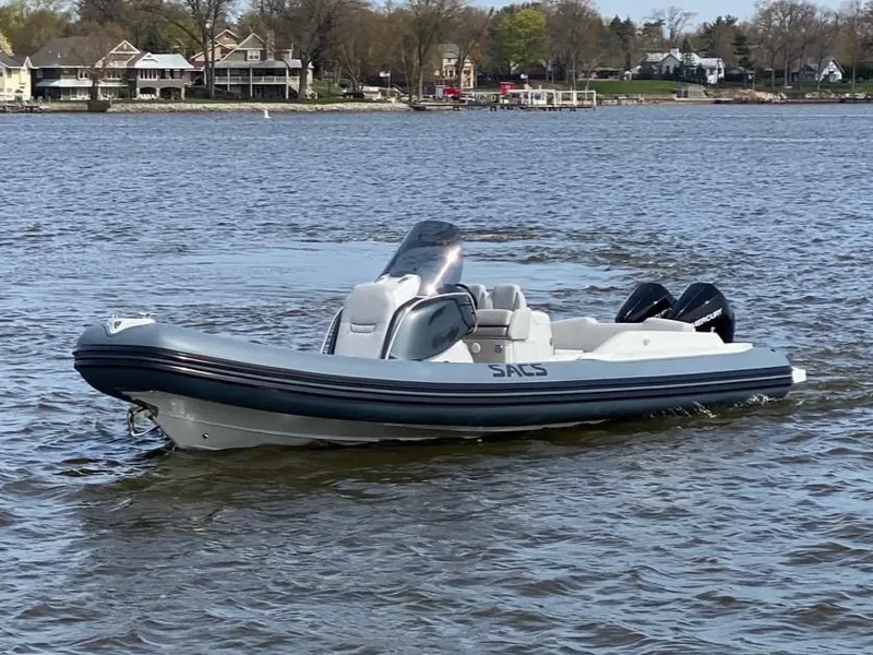 Slide: The Image of 2022 SACS Strider 900 inflatable boat on a lake. - 2