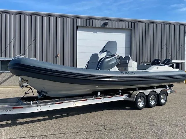 Slide: The Image of 2022 SACS Strider 900 boat on a trailer outside a warehouse. - 3