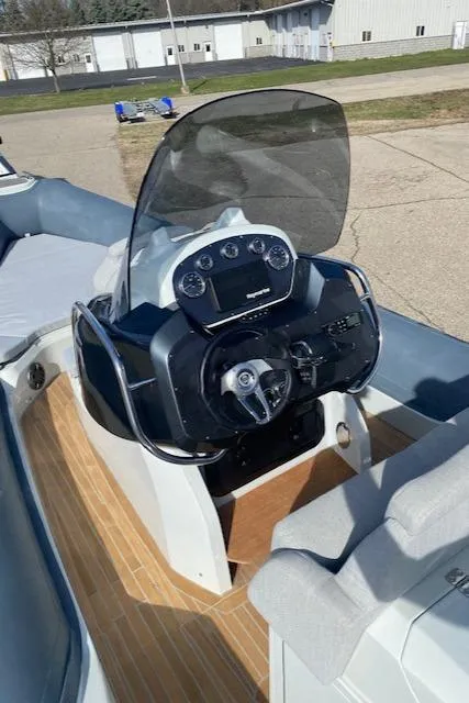 Slide: The Image of 2022 SACS Strider 900 boat dashboard with steering wheel and control panel. - 7