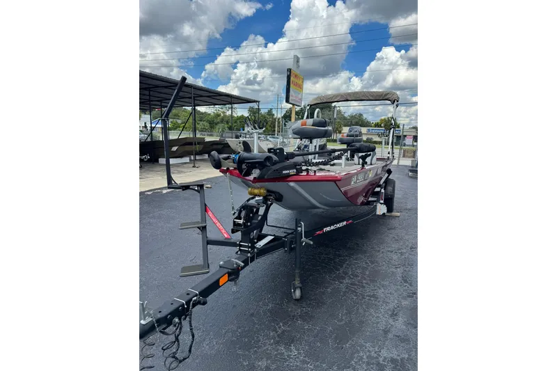 Slide: The Image of 2022 Tracker Pro 170 boat on trailer under cloudy sky at dealership. - 2