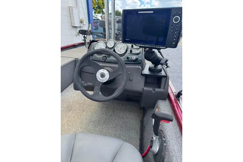 Slide: The Image of 2022 Tracker Pro 170 boat dashboard with steering wheel and Humminbird fish finder. - 6
