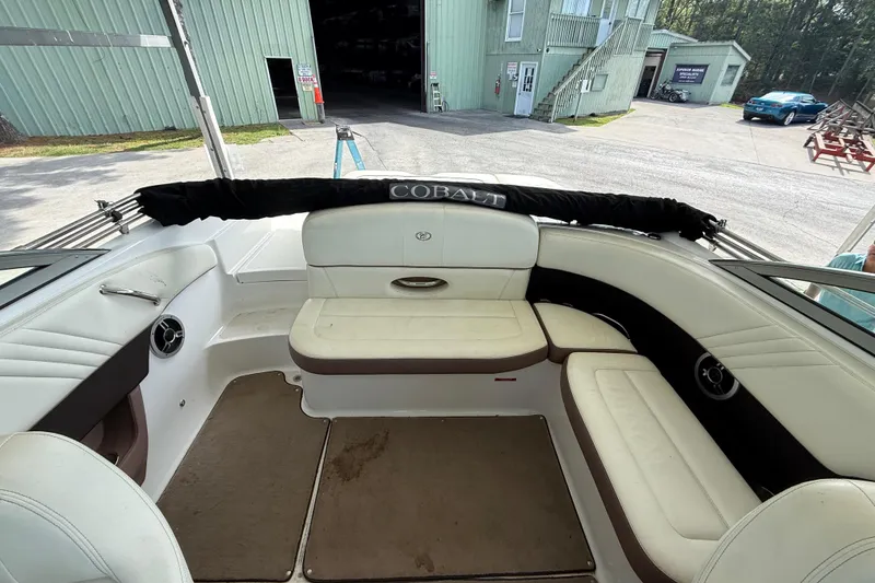 Slide: The Image of Interior of a 2011 Cobalt 232 boat with white seating and brown accents. - 3