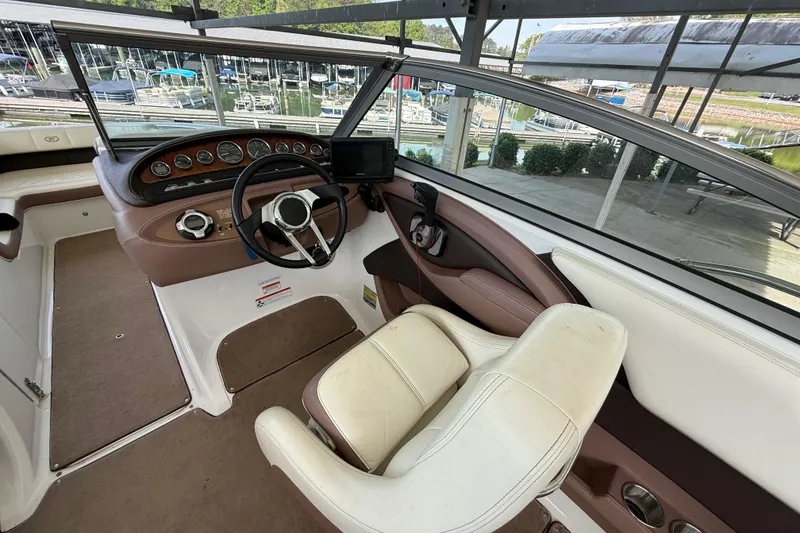 Slide: The Image of 2011 Cobalt 232 boat cockpit with steering wheel and dashboard controls. - 4