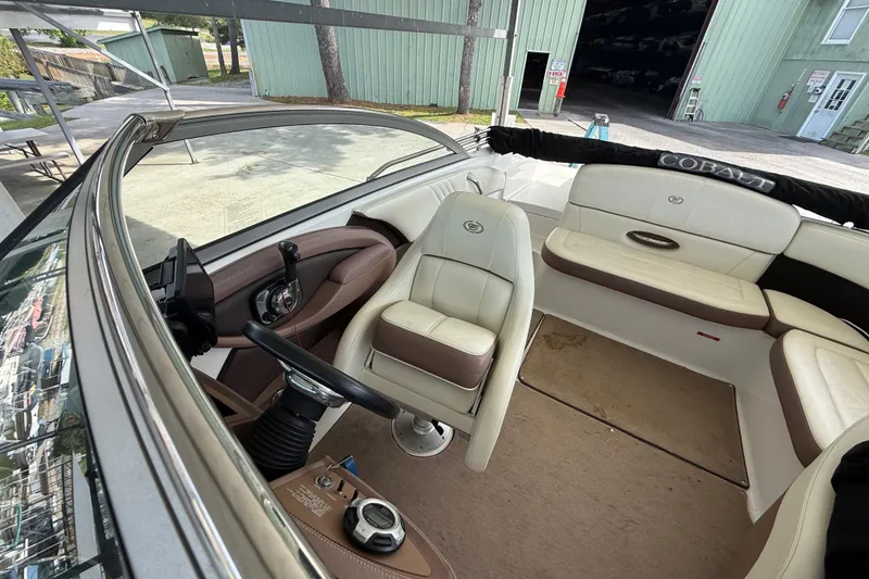 Slide: The Image of Interior of a 2011 Cobalt 232 boat with white and brown seating. - 5