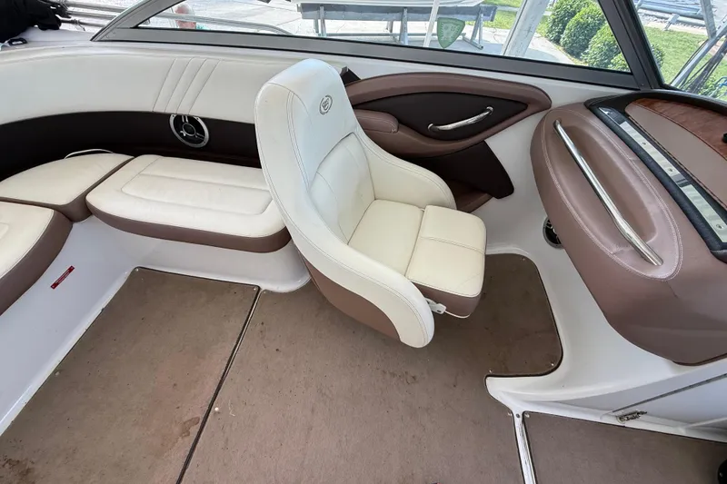 Slide: The Image of Interior of a 2011 Cobalt 232 boat with white and brown seating. - 6