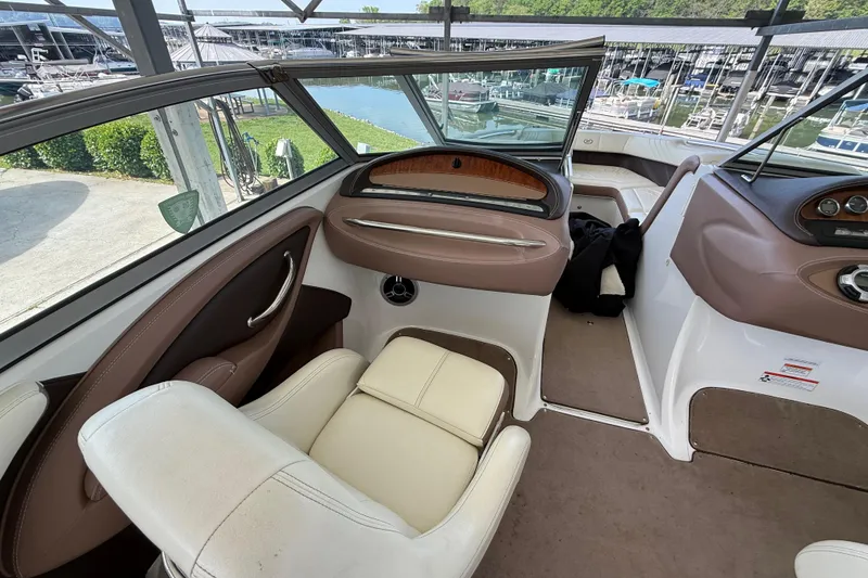 Slide: The Image of Interior of a 2011 Cobalt 232 boat with beige and brown seating. - 7