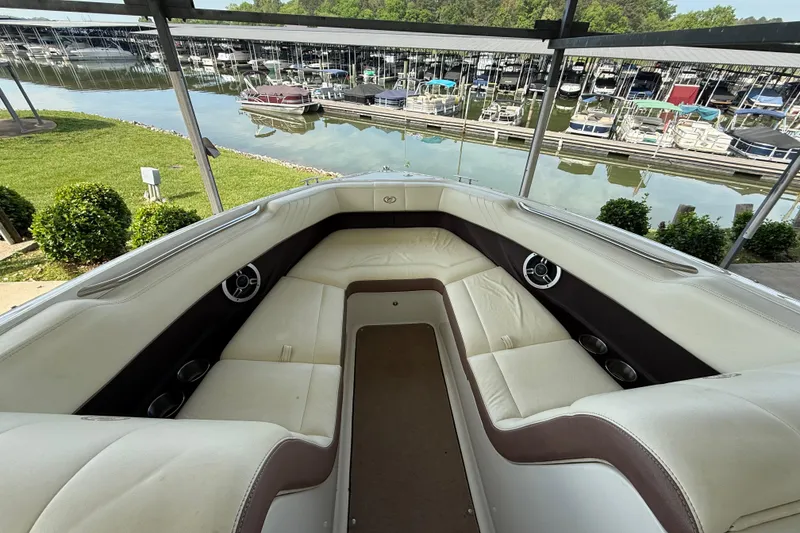 Slide: The Image of Interior view of a 2011 Cobalt 232 boat docked at a marina. - 9