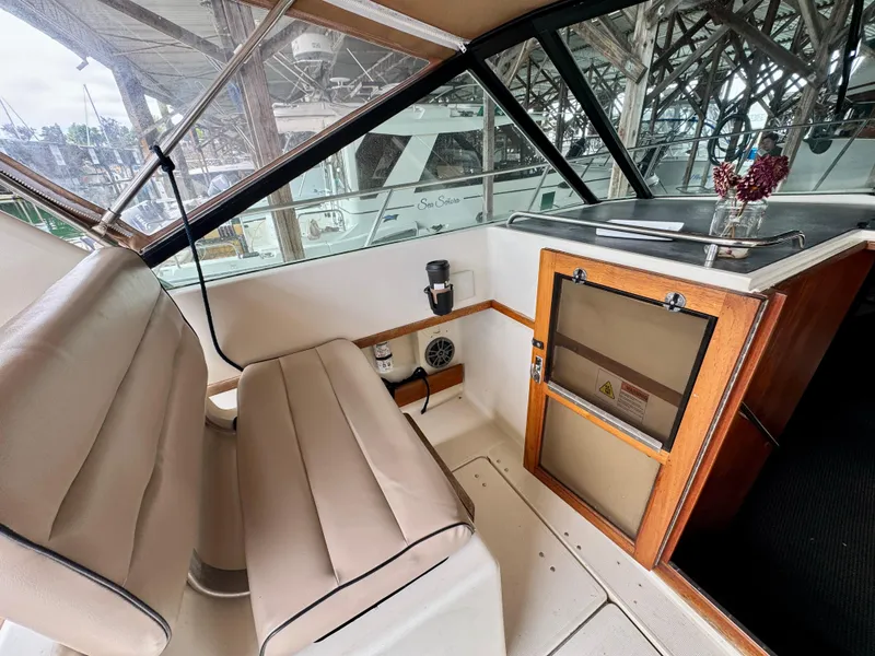 Slide: The Image of 1988 Tiara Yachts 3100 Open interior with helm, seating, and navigation equipment. - 10