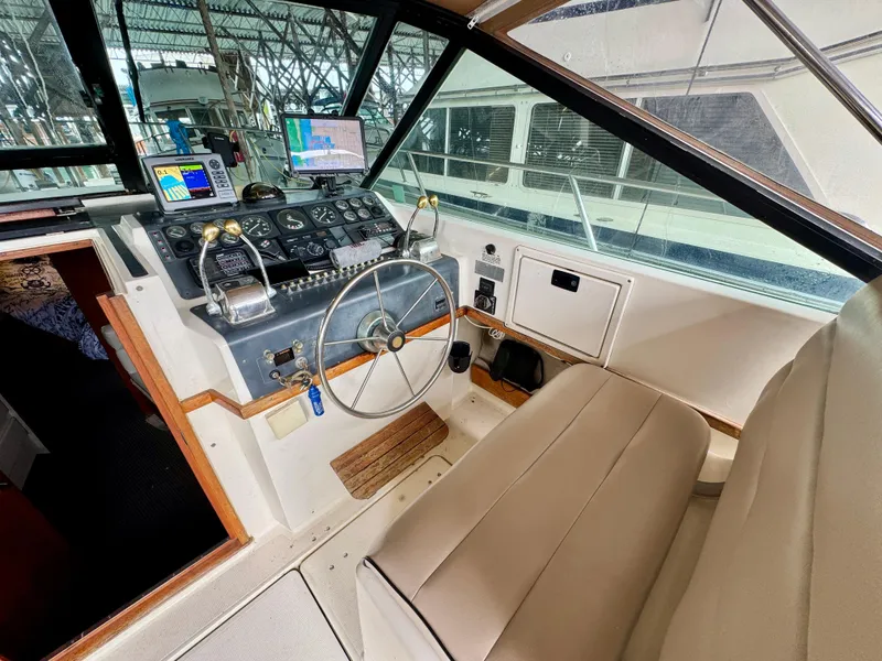 Slide: The Image of 1988 Tiara Yachts 3100 Open interior with seating and wooden cabinetry. - 11
