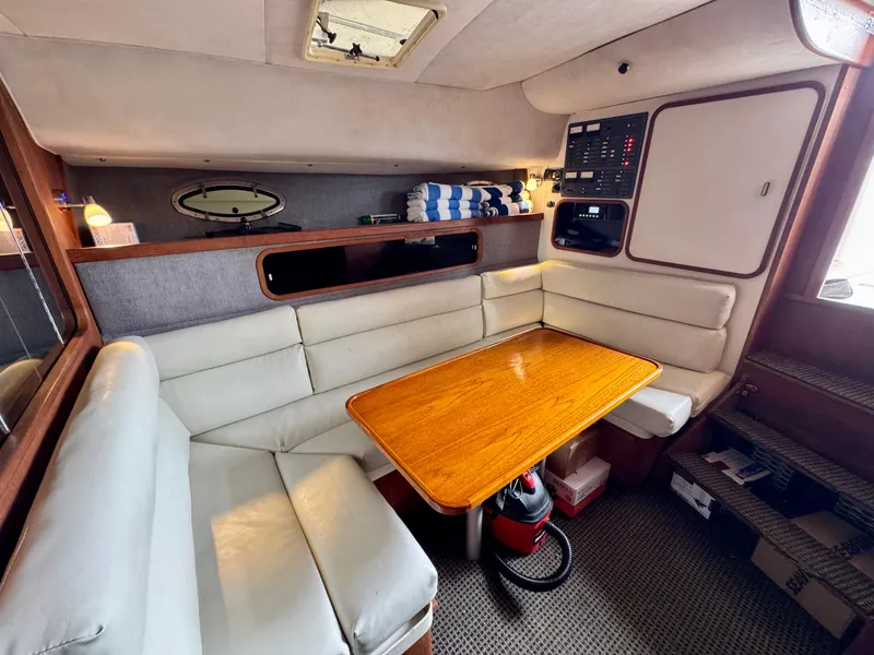 Slide: The Image of 1988 Tiara Yachts 3100 Open interior with cozy seating and wooden table. - 16