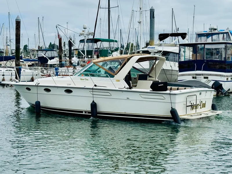 Slide: The Image of 1988 Tiara Yachts 3100 Open in marina, surrounded by other boats. - 2