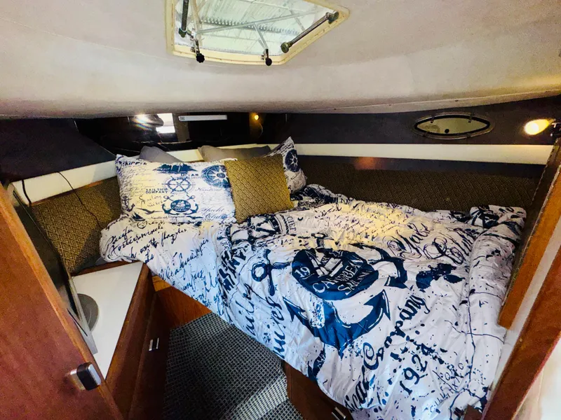 Slide: The Image of 1988 Tiara Yachts 3100 Open galley with sink, stove, and window. - 20