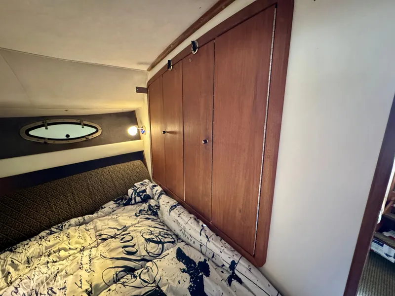 Slide: The Image of Cozy cabin interior of 1988 Tiara Yachts 3100 Open with nautical-themed bedding. - 21