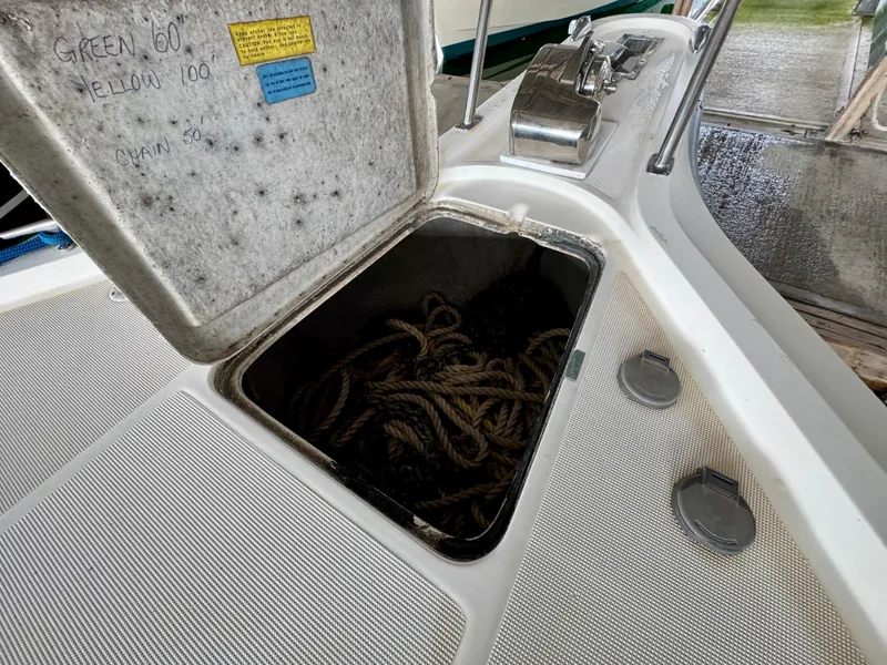 Slide: The Image of 1988 Tiara Yachts 3100 Open with beige canopy, docked at marina. - 26