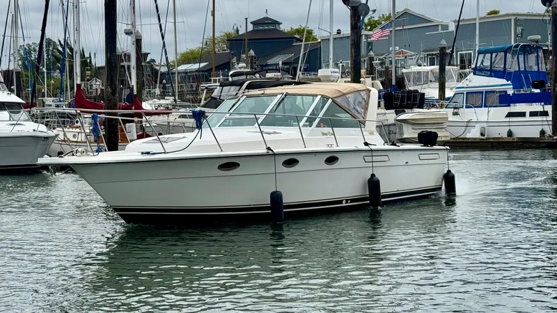 Slide: The Image of 1988 Tiara Yachts 3100 Open in marina, surrounded by other boats. - 32
