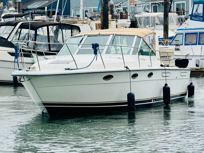Slide: The Image of 1988 Tiara Yachts 3100 Open in marina, surrounded by other boats. - 33
