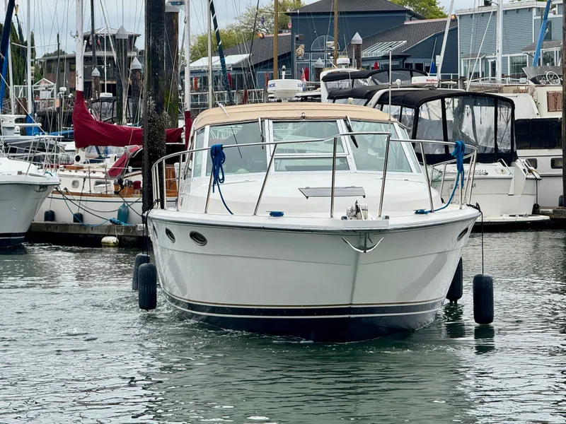 Slide: The Image of 1988 Tiara Yachts 3100 Open in marina, surrounded by other boats. - 37