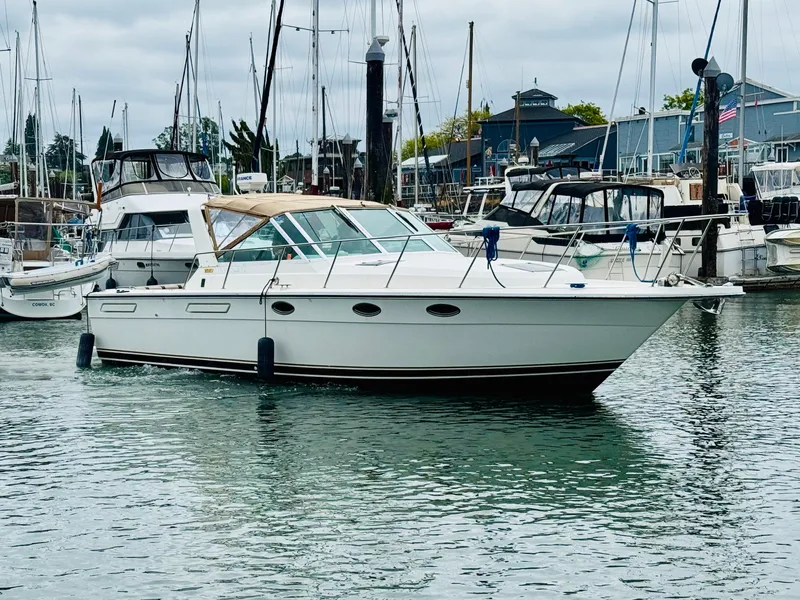 Slide: The Image of 1988 Tiara Yachts 3100 Open in marina, surrounded by other boats. - 39