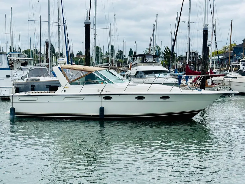 Slide: The Image of 1988 Tiara Yachts 3100 Open in marina, surrounded by other boats. - 4