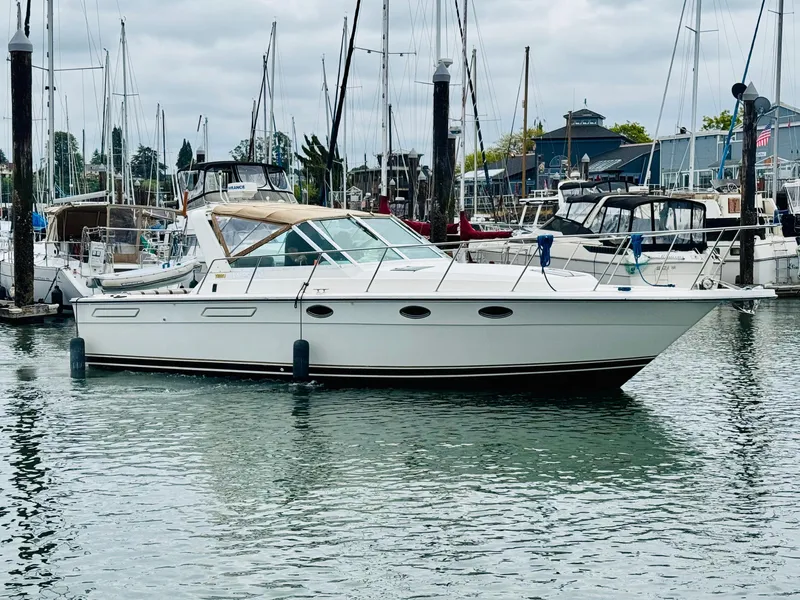 Slide: The Image of 1988 Tiara Yachts 3100 Open in marina, surrounded by other boats. - 40