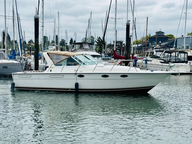 Slide: The Image of 1988 Tiara Yachts 3100 Open docked in a marina, surrounded by other boats. - 41